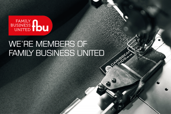A sewing machine stitches fabric labeled "CARIBBEAN BLINDS UK LTD" in a close-up view. Text reads: "FAMILY BUSINESS UNITED fbu. WE'RE MEMBERS OF FAMILY BUSINESS UNITED."