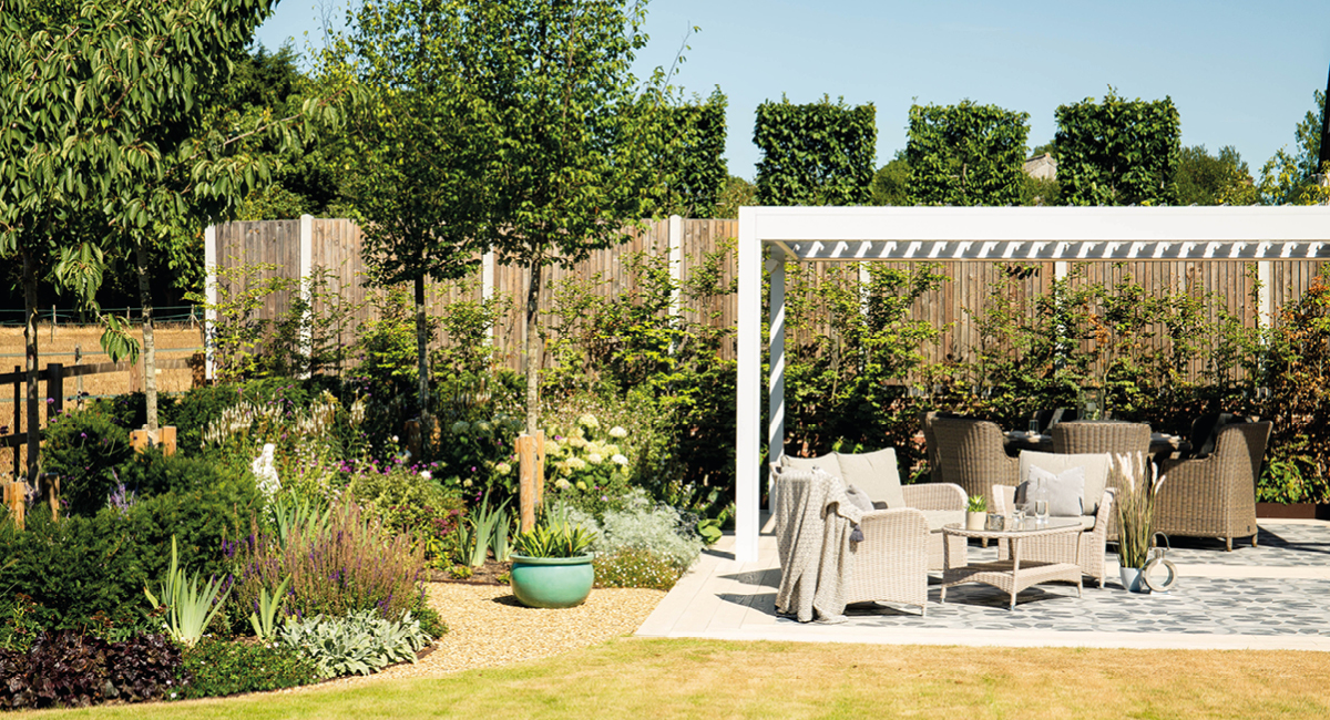 Dedicated outdoor living space with a white aluminium louvered pergola