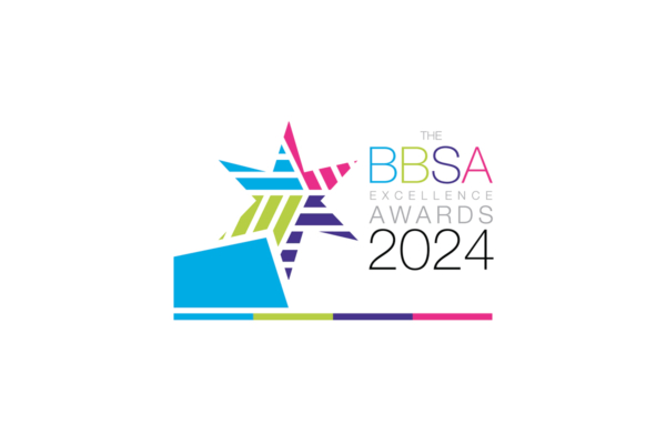 A multicolored geometric star rests above a blue platform, surrounded by text: "THE BBSA EXCELLENCE AWARDS 2024" on a white background. A colored stripe runs horizontally below the text.