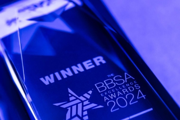 A shiny blue award displays the text "WINNER" and "THE BBSA EXCELLENCE AWARDS 2024," featuring a star design, set against a softly lit background.