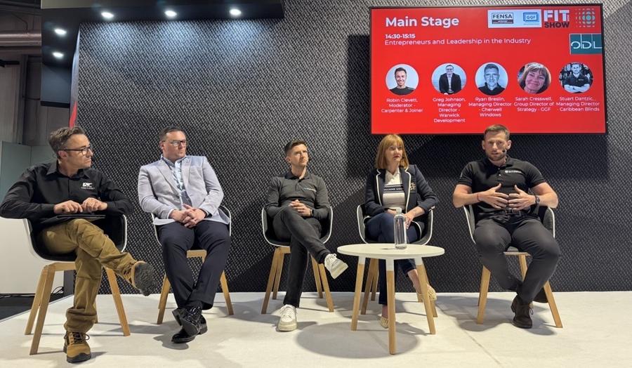 Panelists are seated, engaging in a discussion on stage. A screen behind them reads: "Main Stage: Entrepreneurs and Leadership in the Industry.