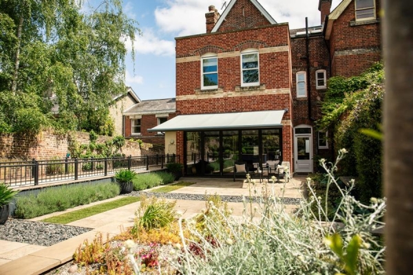 An extended awning covers a patio area,