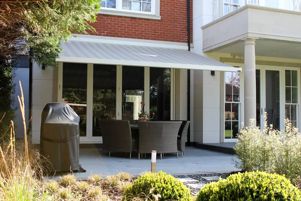 a patio awning over a set of outdoor chairs and a table